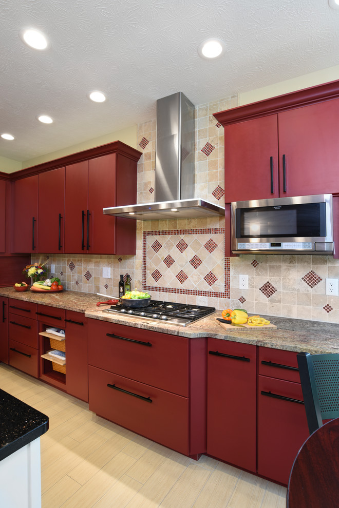 Enclosed kitchen - large transitional porcelain tile and beige floor enclosed kitchen idea with an undermount sink, flat-panel cabinets, red cabinets, granite countertops, beige backsplash, travertine backsplash, stainless steel appliances and an island