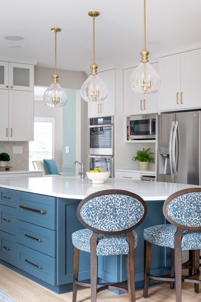 Example of a large transitional light wood floor and brown floor eat-in kitchen design with a drop-in sink, shaker cabinets, quartz countertops, gray backsplash and an island