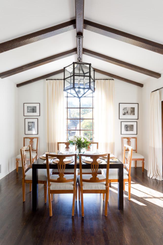 Inspiration for a mediterranean dining room in Los Angeles with white walls and dark hardwood floors.