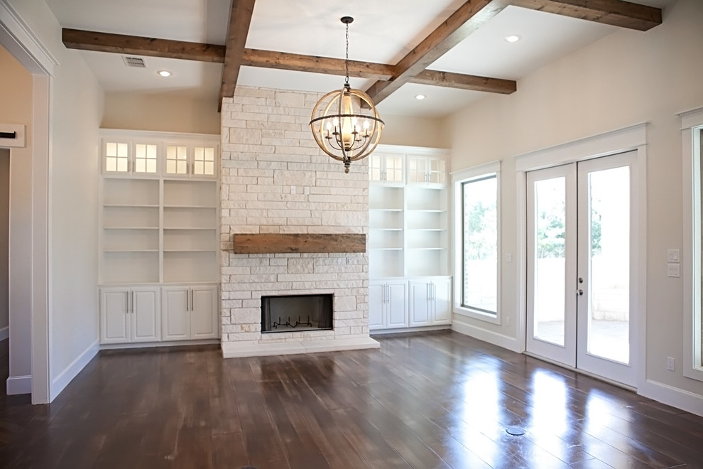Large arts and crafts formal open concept living room in Austin with white walls, concrete floors, a standard fireplace, a stone fireplace surround and a wall-mounted tv.