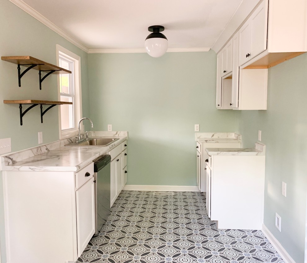 Photo of a small arts and crafts galley laundry room in Other with a drop-in sink, shaker cabinets, white cabinets, laminate benchtops, blue splashback, vinyl floors, blue floor and white benchtop.