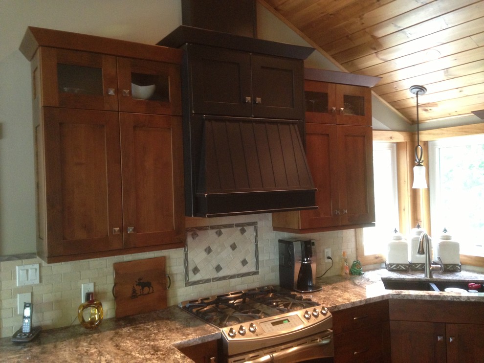 Inspiration for a mid-sized rustic u-shaped medium tone wood floor eat-in kitchen remodel in Toronto with a double-bowl sink, shaker cabinets, dark wood cabinets, quartz countertops, multicolored backsplash, ceramic backsplash and stainless steel appliances