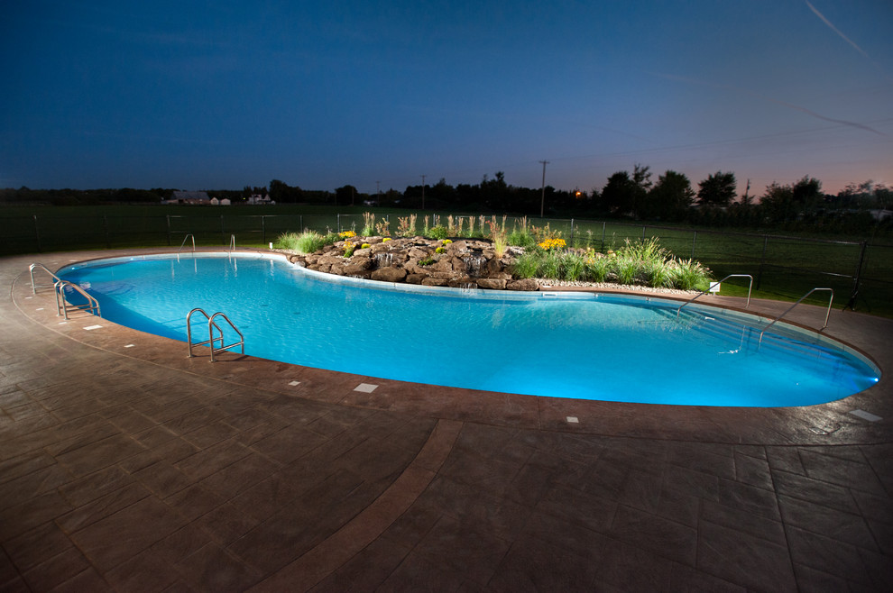 Inspiration for a huge rustic courtyard stamped concrete and freeform natural pool fountain remodel
