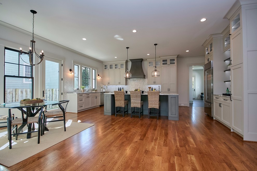 Photo of a large country u-shaped open plan kitchen in DC Metro with a single-bowl sink, shaker cabinets, grey cabinets, quartzite benchtops, multi-coloured splashback, marble splashback, stainless steel appliances, medium hardwood floors, with island, brown floor and multi-coloured benchtop.