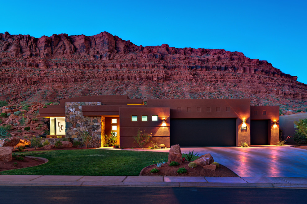 Inspiration for a one-storey adobe red exterior in Salt Lake City with a flat roof.