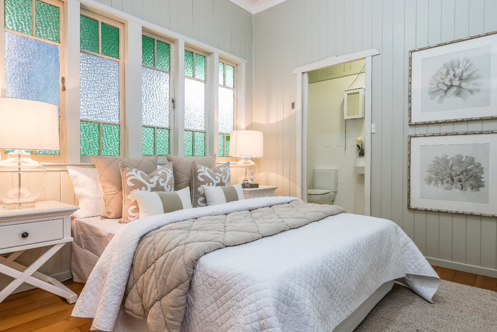 Inspiration for a country bedroom in Brisbane with grey walls, medium hardwood floors and brown floor.