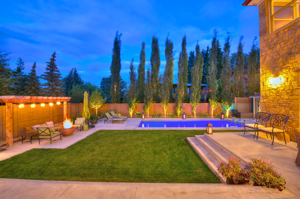 Design ideas for a mid-sized traditional backyard pool in Calgary.