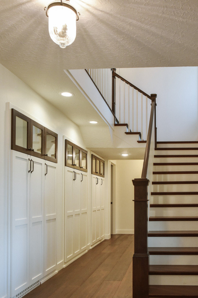 This is an example of a mid-sized country wood l-shaped staircase in Portland with painted wood risers and wood railing.
