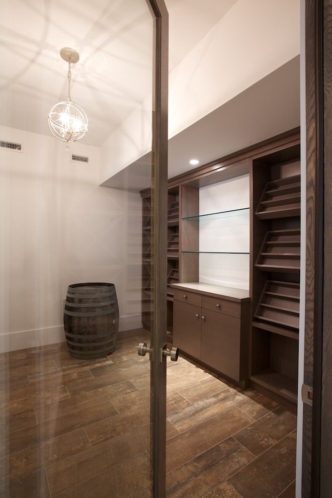 Inspiration for a mid-sized transitional ceramic tile wine cellar remodel with display racks