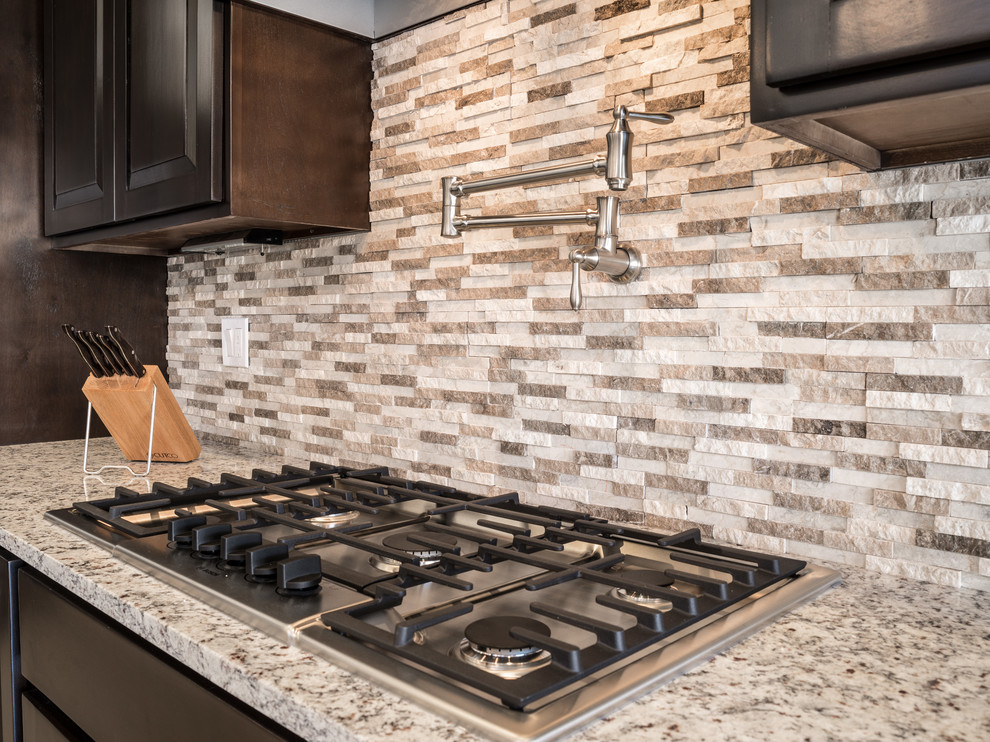 Mid-sized transitional galley marble floor eat-in kitchen photo in Austin with a farmhouse sink, raised-panel cabinets, dark wood cabinets, granite countertops, brown backsplash, stone tile backsplash and no island