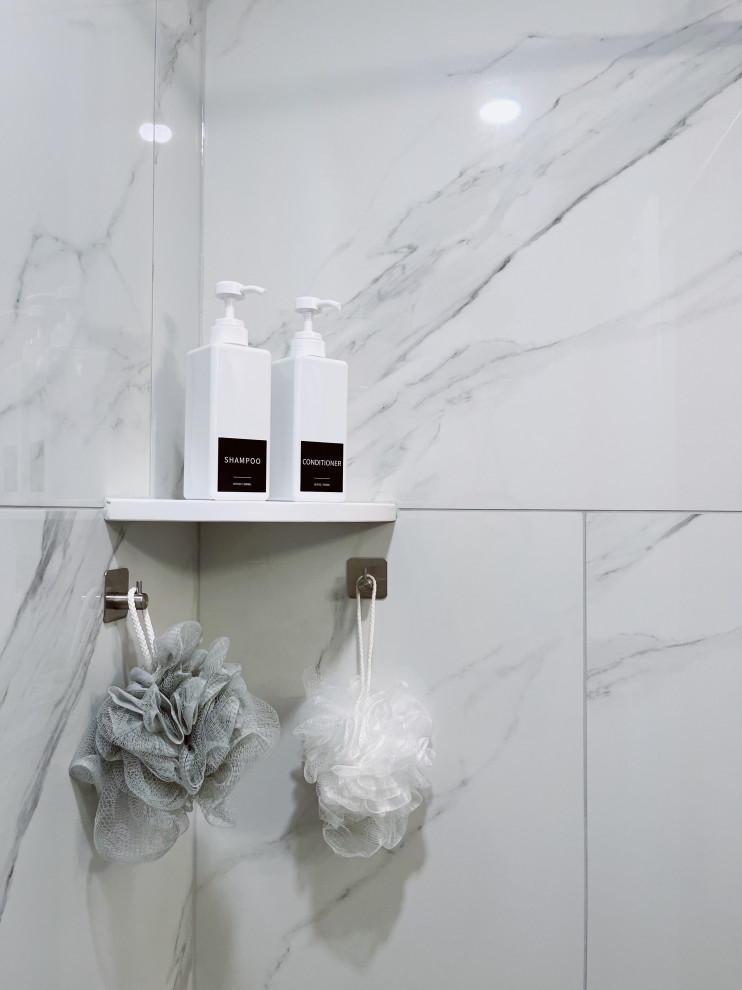 Inspiration for a small transitional kids' white tile and porcelain tile porcelain tile, white floor and single-sink alcove shower remodel with shaker cabinets, white cabinets, a two-piece toilet, blue walls, an undermount sink, marble countertops, gray countertops and a freestanding vanity