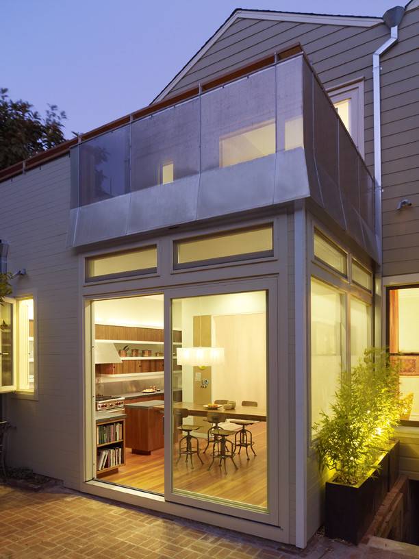 Inspiration for a modern green exterior in San Francisco with wood siding and a gable roof.