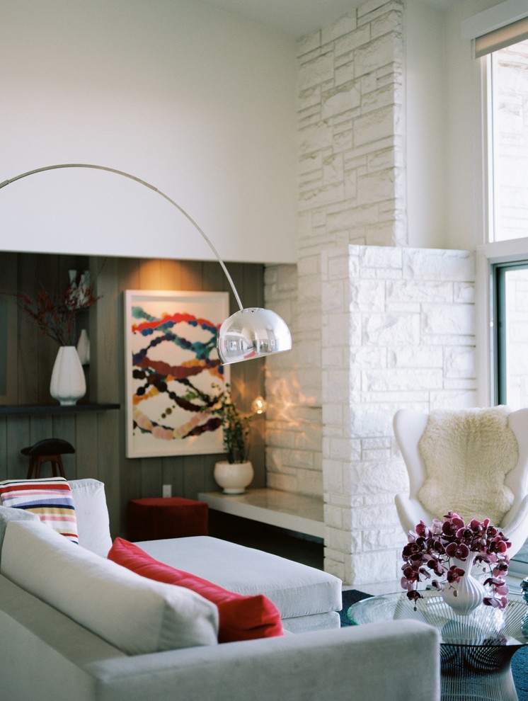 Inspiration for a large midcentury open concept family room in Los Angeles with a standard fireplace, no tv, beige walls, travertine floors, a stone fireplace surround and beige floor.