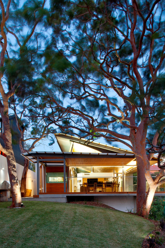 This is an example of a mid-sized contemporary two-storey brick white exterior in Sydney.