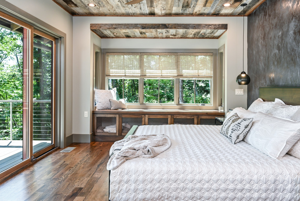 Inspiration for a mid-sized country master bedroom in Other with grey walls, brown floor, medium hardwood floors and no fireplace.