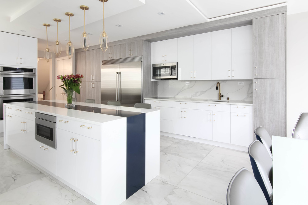 Photo of a large contemporary eat-in kitchen in New York with an undermount sink, flat-panel cabinets, white cabinets, quartzite benchtops, stone slab splashback, stainless steel appliances, with island, white benchtop, white splashback and white floor.