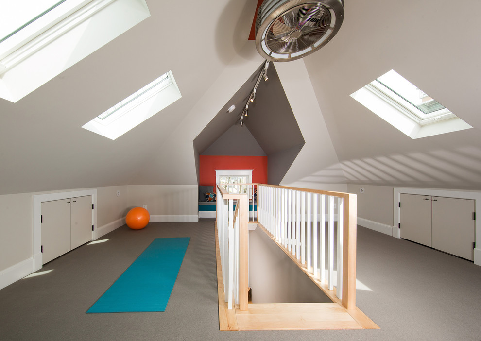 This is an example of a mid-sized transitional home gym in DC Metro with multi-coloured walls and carpet.