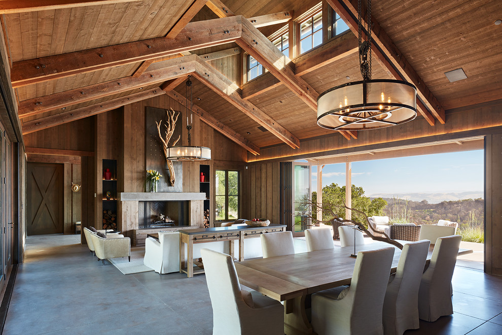 This is an example of a country open plan dining in San Francisco with concrete floors and grey floor.