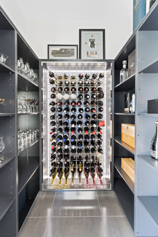 Small contemporary wine cellar in Gold Coast - Tweed with ceramic floors, storage racks and grey floor.