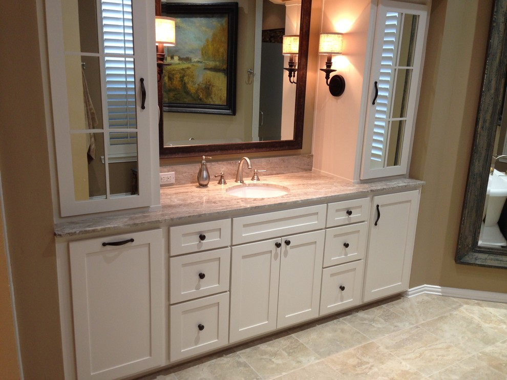 Inspiration for a large traditional master bathroom in Dallas with an undermount sink, a freestanding tub, ceramic tile, ceramic floors, shaker cabinets, white cabinets, brown walls, granite benchtops and grey floor.