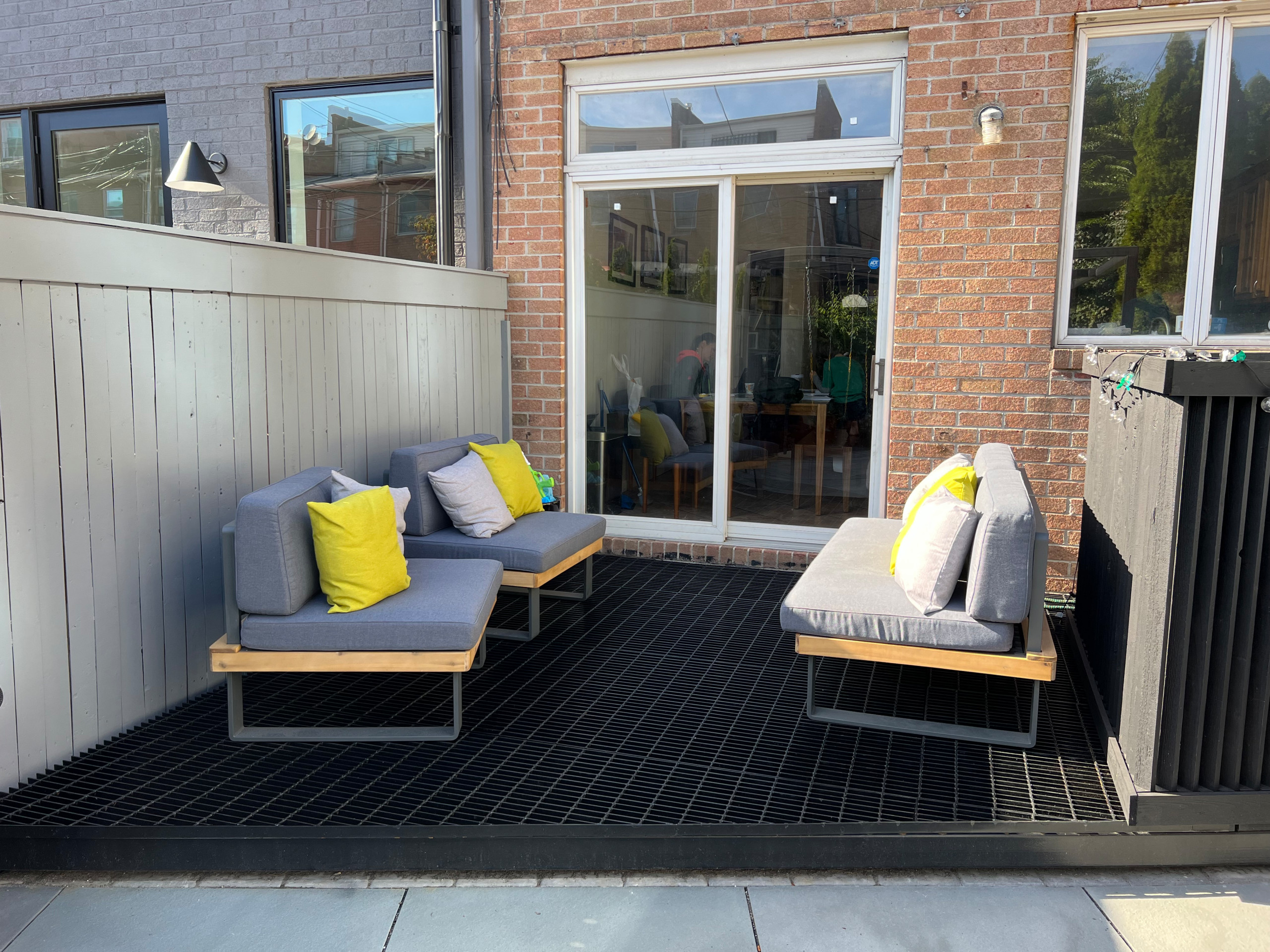 Paved patio with metal grating garden