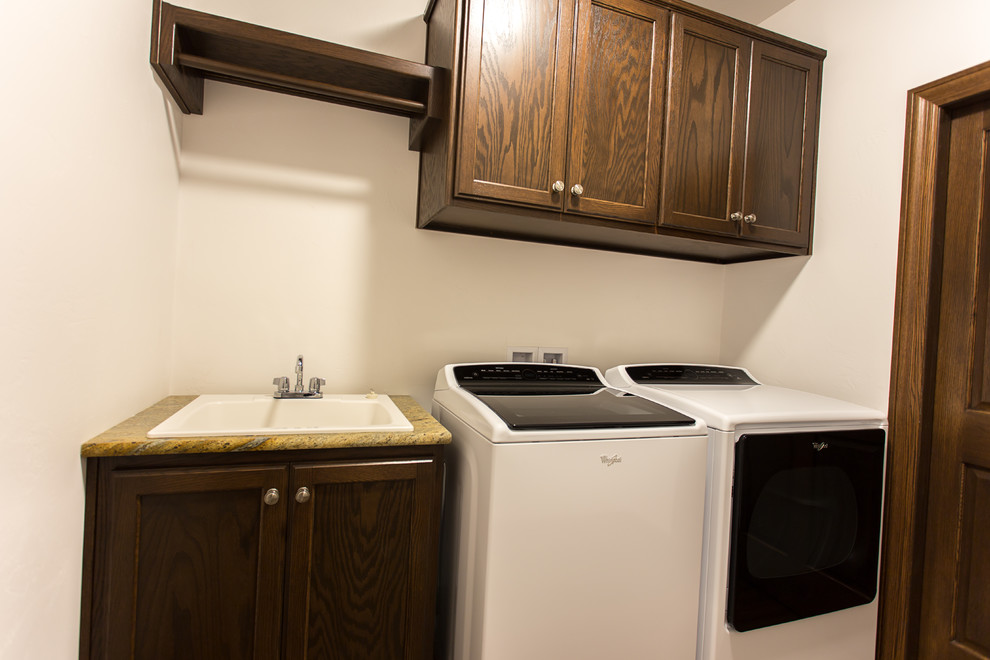 Small traditional single-wall dedicated laundry room in Other with an undermount sink, shaker cabinets, dark wood cabinets, white walls and a side-by-side washer and dryer.