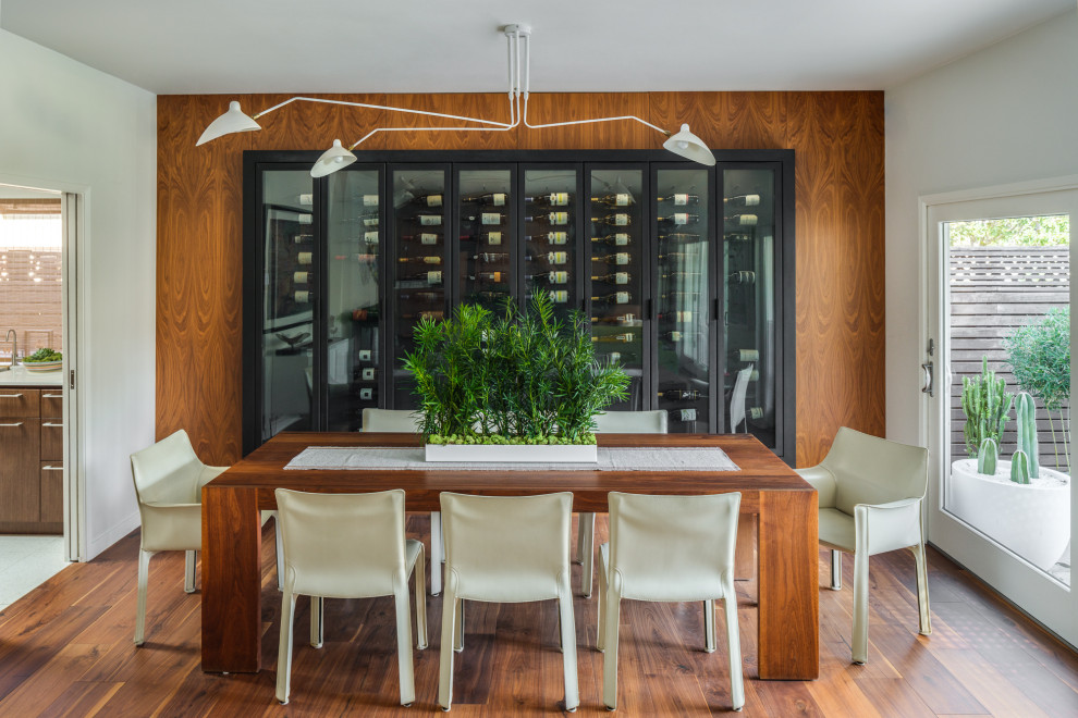 Medium sized midcentury dining room in San Francisco with white walls, dark hardwood flooring and brown floors.