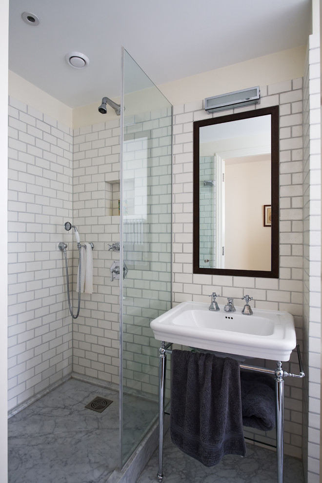 Inspiration for a small contemporary master bathroom in London with flat-panel cabinets, brown cabinets, an open shower, a wall-mount toilet, white tile, ceramic tile, white walls, marble floors, a pedestal sink, grey floor and an open shower.