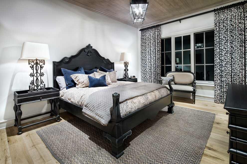 Photo of a mediterranean guest bedroom in Austin with light hardwood floors.
