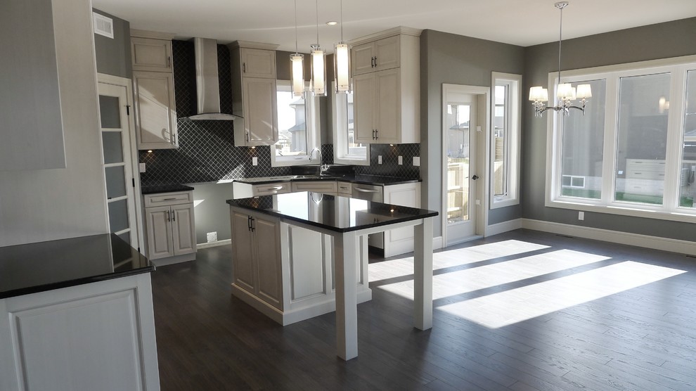 Open concept kitchen - mid-sized transitional u-shaped open concept kitchen idea with raised-panel cabinets, white cabinets, granite countertops, black backsplash, ceramic backsplash and an island