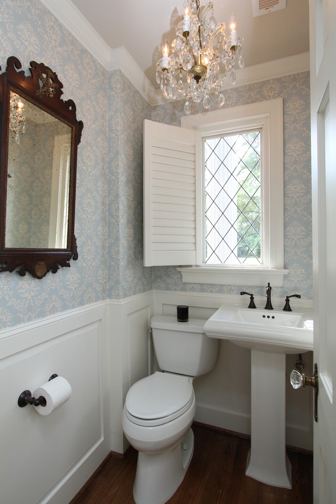 Design ideas for a small traditional powder room in Houston with a two-piece toilet, medium hardwood floors and a pedestal sink.