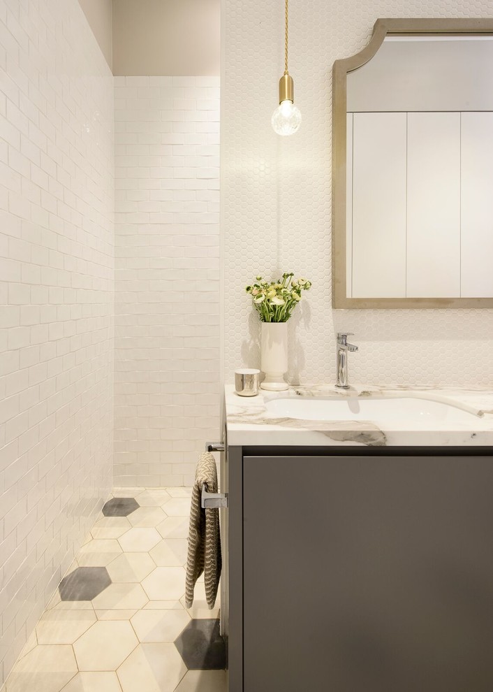 Design ideas for a bathroom in Sydney with flat-panel cabinets, grey cabinets, an open shower, a two-piece toilet, white tile, ceramic tile, grey walls, concrete floors, an undermount sink and marble benchtops.