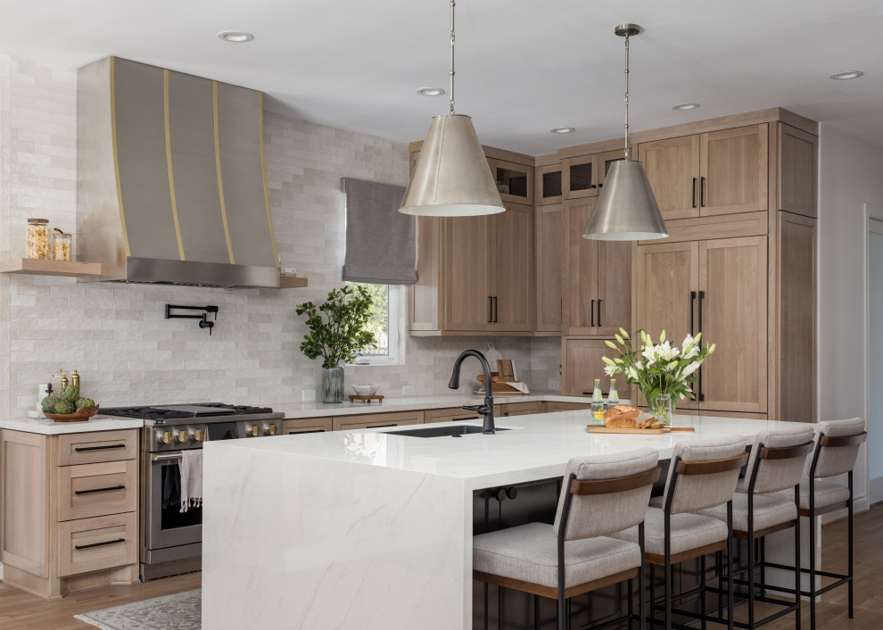 Transitional eat-in kitchen photo in Houston with light wood cabinets and an island