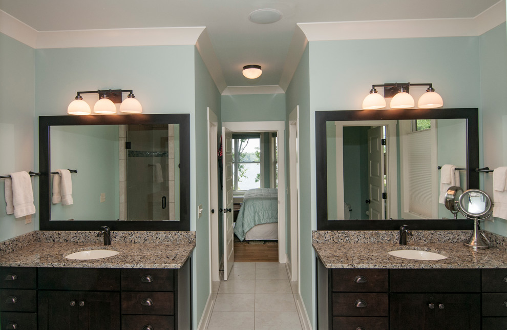 Example of a large arts and crafts master beige tile bathroom design in Other with dark wood cabinets and blue walls