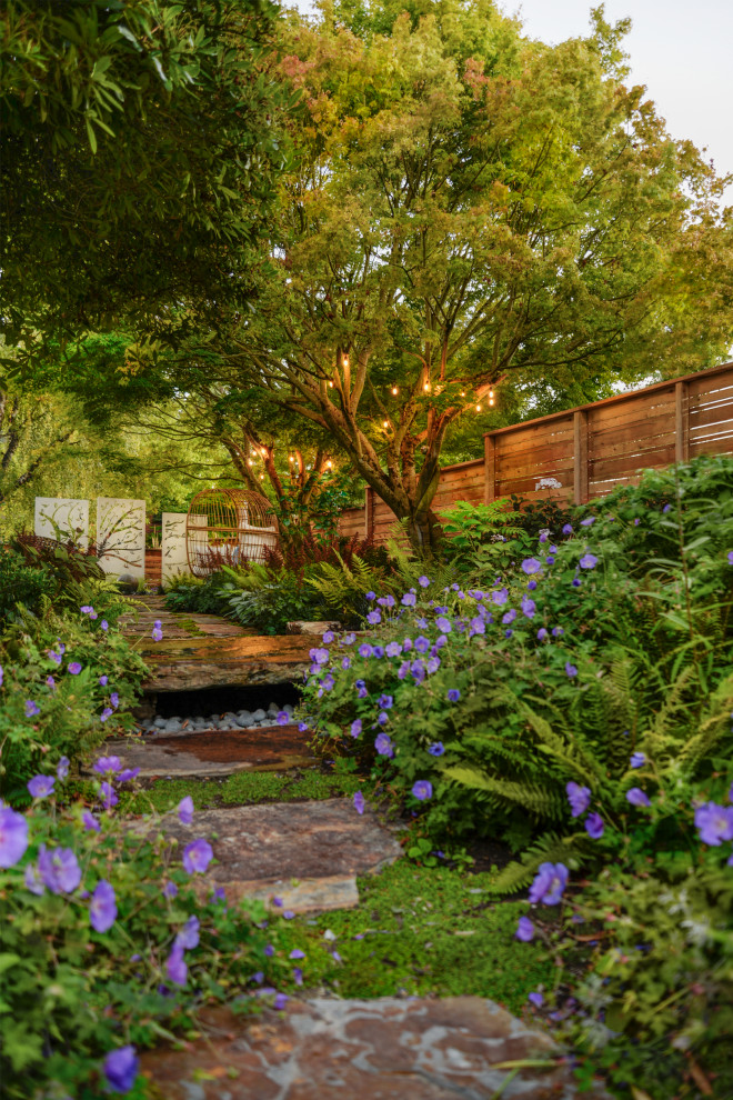 Inspiration for a mid-sized eclectic backyard partial sun garden in Seattle with with path and natural stone pavers.
