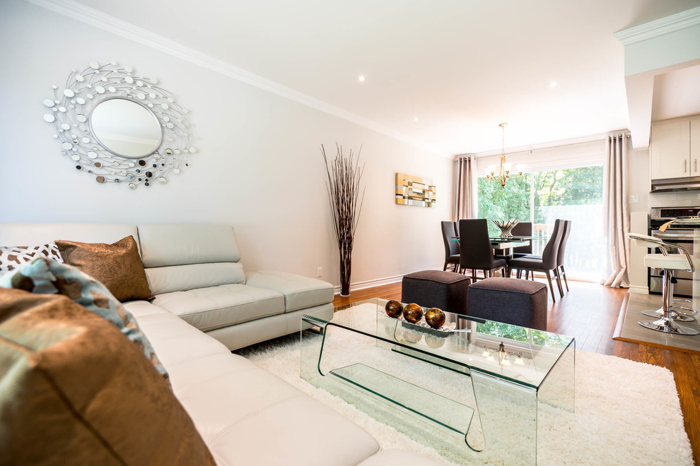 Living room - huge modern open concept medium tone wood floor living room idea in Montreal with gray walls