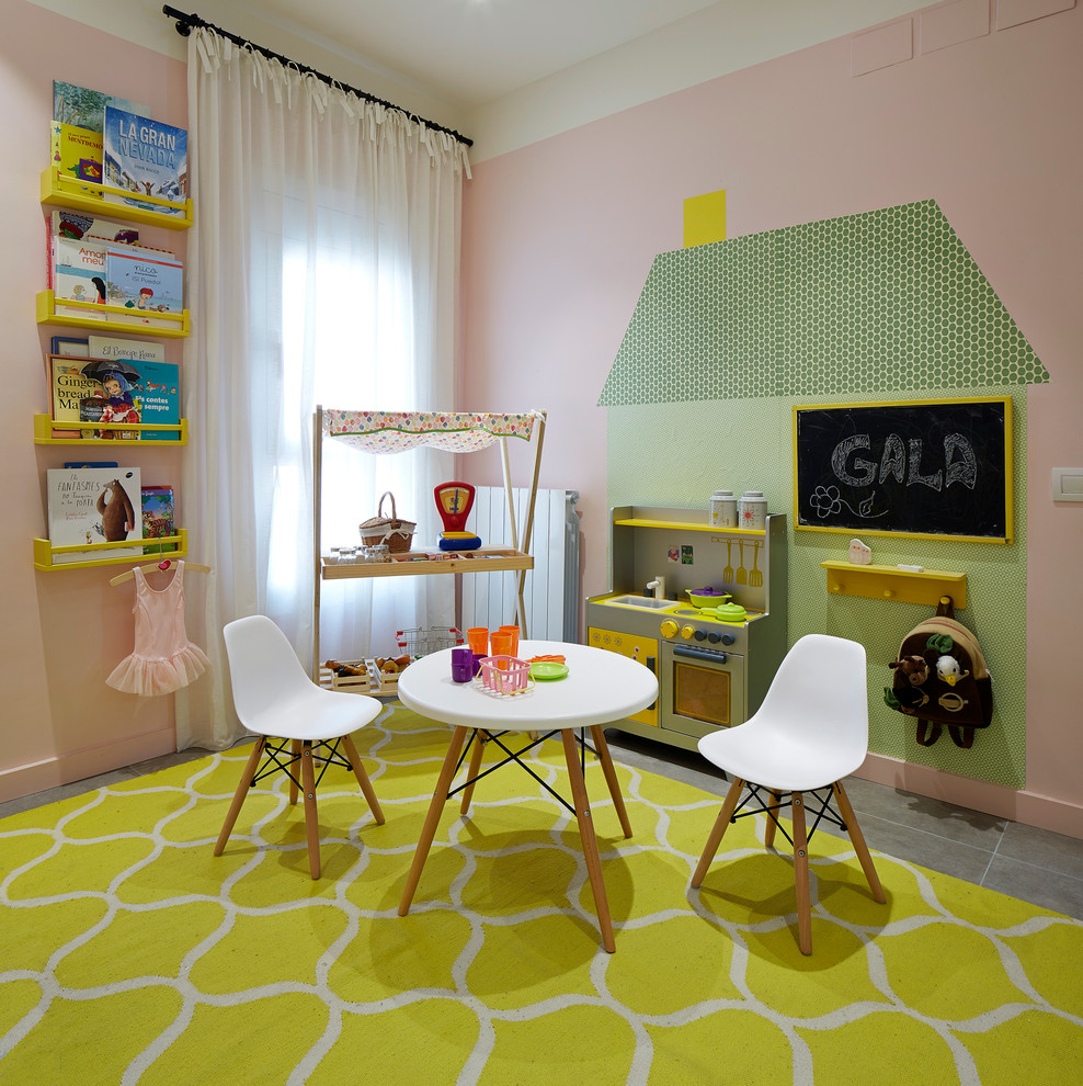 Photo of a mid-sized contemporary kids' room for girls in Barcelona with pink walls.