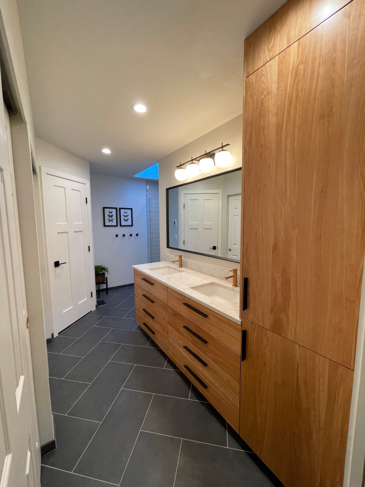 This is an example of a small contemporary master bathroom in Seattle with flat-panel cabinets, medium wood cabinets, an alcove shower, gray tile, ceramic tile, white walls, porcelain floors, an undermount sink, engineered quartz benchtops, black floor, a hinged shower door, beige benchtops, a niche, a double vanity and a built-in vanity.