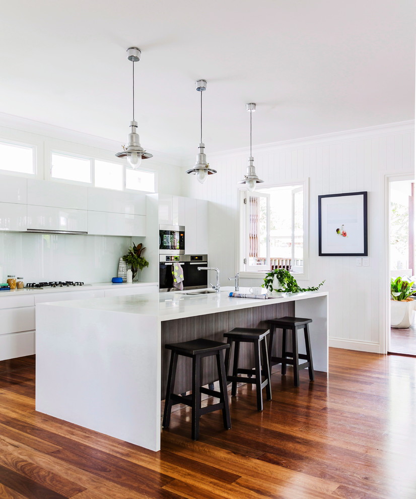 This is an example of a large contemporary single-wall kitchen in Sydney with with island.