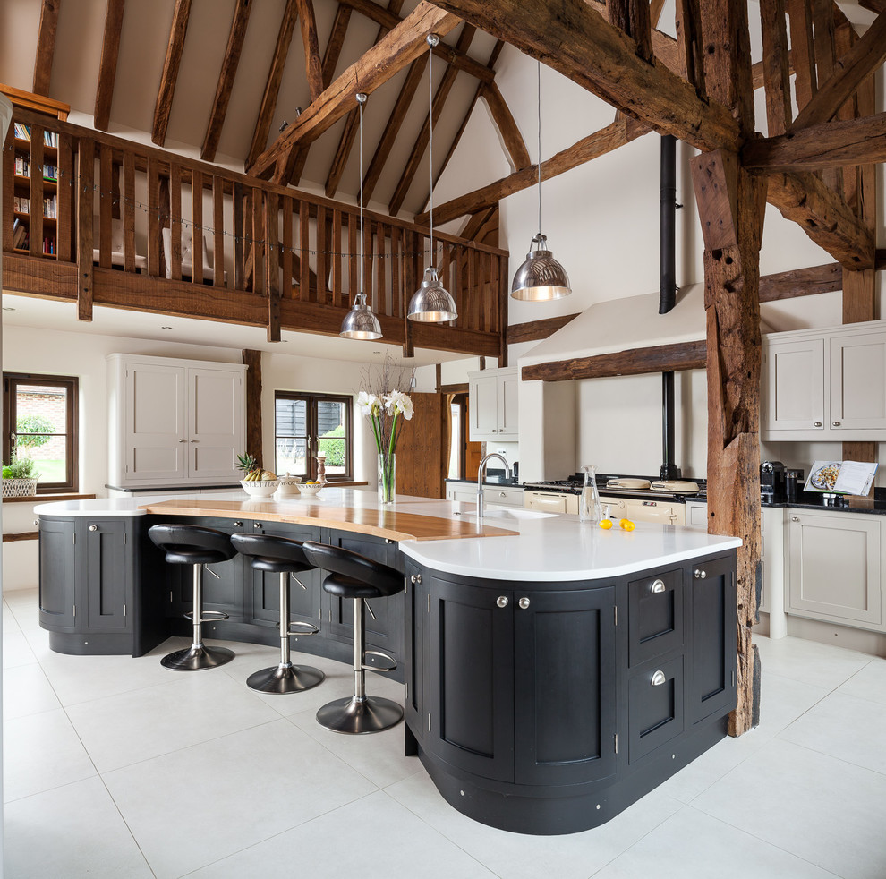 This is an example of a country kitchen in Other with shaker cabinets, black cabinets, coloured appliances, with island and white floor.