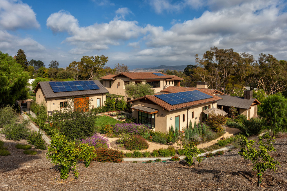 Tuscan beige two-story exterior home photo in Orange County with a mixed material roof