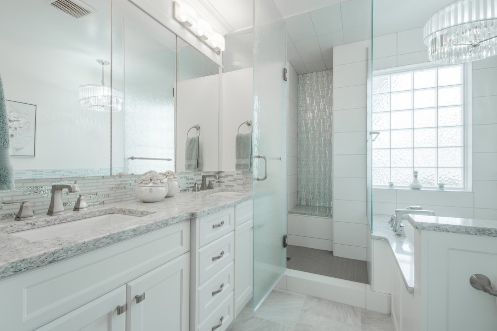 Inspiration for a small transitional master bathroom in Calgary with shaker cabinets, white cabinets, a two-piece toilet, black and white tile, blue walls, mosaic tile floors, a pedestal sink, an undermount tub, an alcove shower, matchstick tile, beige floor and a hinged shower door.