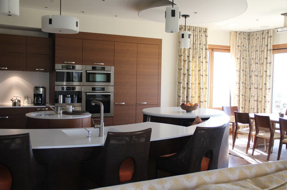 Example of a large transitional kitchen design in Denver with flat-panel cabinets, dark wood cabinets and an island