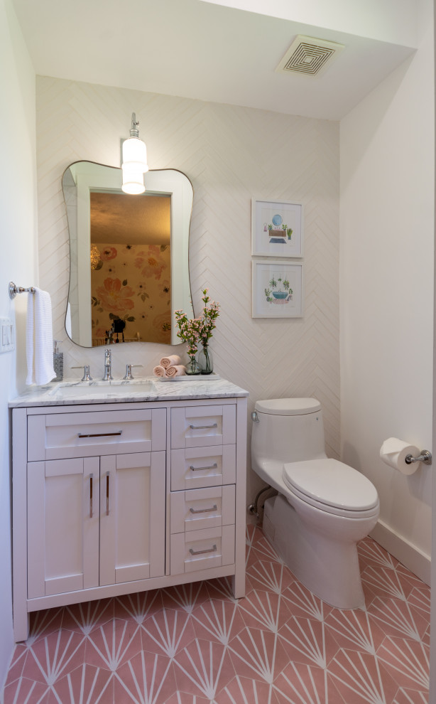 This is an example of a mid-sized transitional kids bathroom in Miami with shaker cabinets, white cabinets, an open shower, a two-piece toilet, white tile, porcelain tile, white walls, marble floors, an undermount sink, engineered quartz benchtops, pink floor, a hinged shower door, white benchtops, a niche, a single vanity and a built-in vanity.
