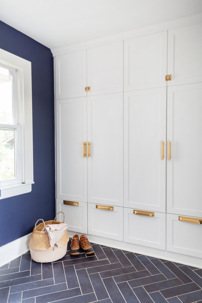 Photo of a small eclectic mudroom in Chicago with blue walls, slate floors, grey floor and decorative wall panelling.