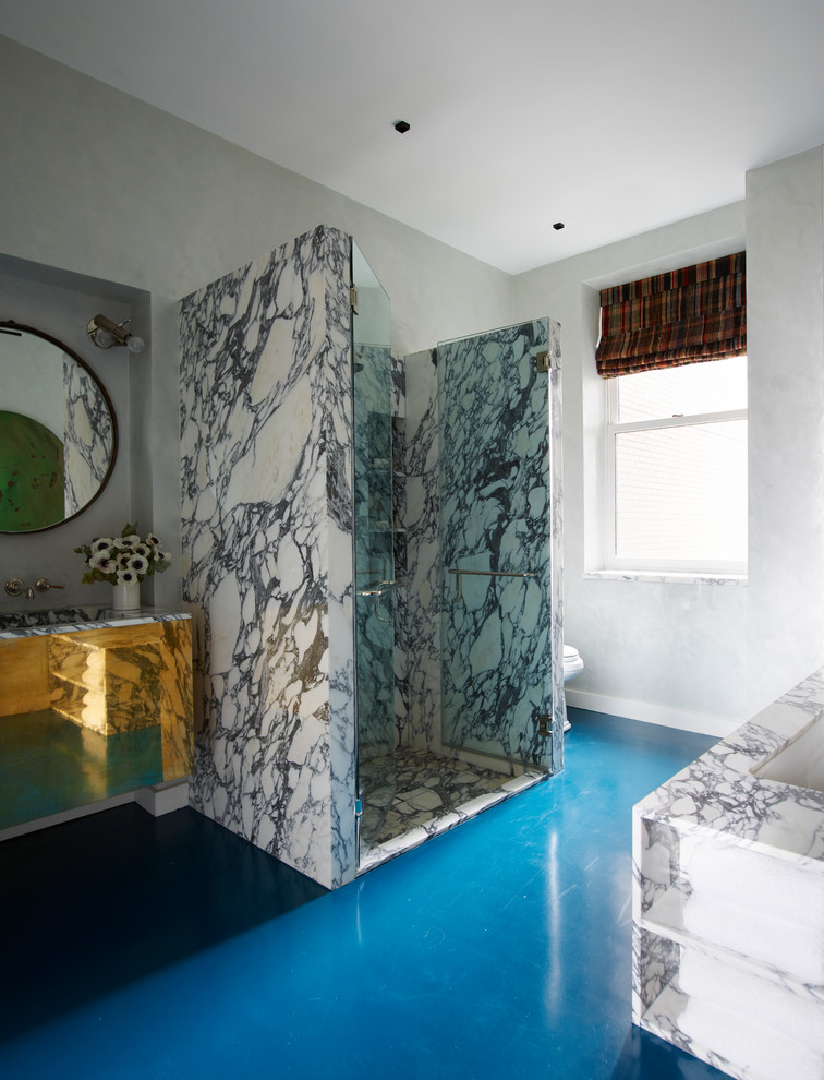 Freestanding bathtub - small eclectic master white tile concrete floor and blue floor freestanding bathtub idea in New York with flat-panel cabinets, brown cabinets, white walls, a wall-mount sink, marble countertops and a hinged shower door