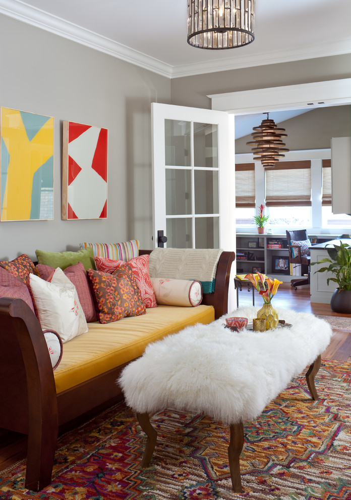 This is an example of a transitional living room in Denver with grey walls.