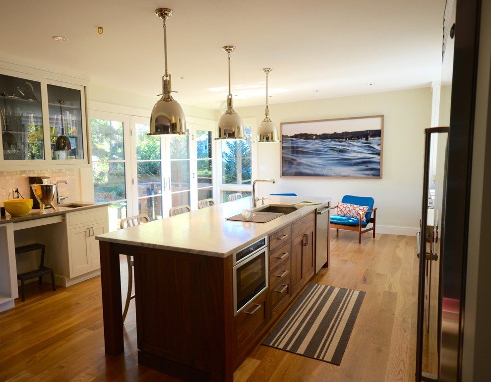 Transitional kitchen photo in Boston with shaker cabinets and an island