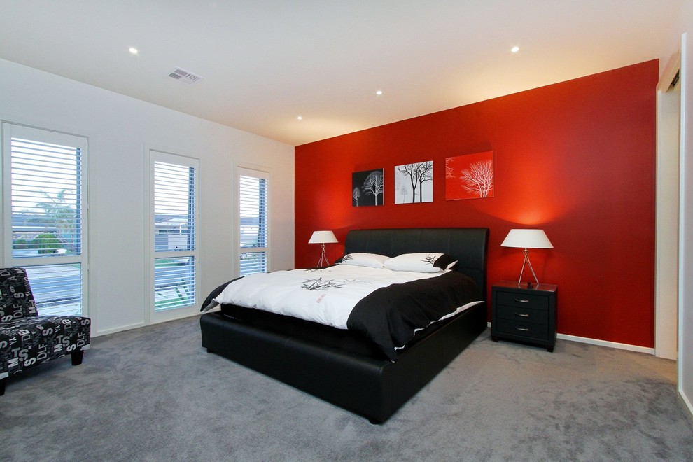 This is an example of a large contemporary master bedroom in Melbourne with red walls, carpet and grey floor.