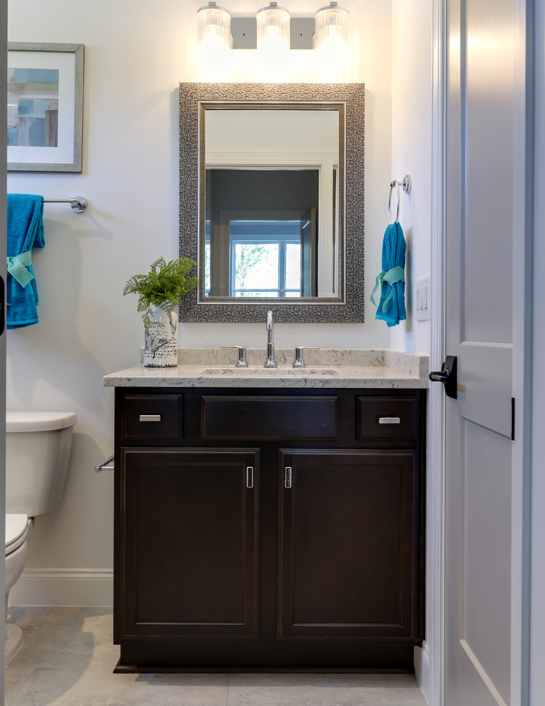 Inspiration for a small transitional 3/4 bathroom in Raleigh with recessed-panel cabinets, dark wood cabinets, white walls, ceramic floors, an undermount sink, engineered quartz benchtops, white floor and beige benchtops.